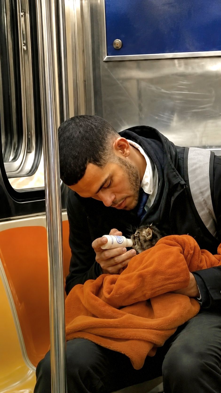 Durante una corsa in metropolitana, un uomo è stato visto mentre proteggeva e alimentava un gattino molto piccolo con il biberon.