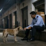 La guardia divide il suo pasto con un cane randagio fuori dalla fabbrica: la scena ripresa dalle telecamere